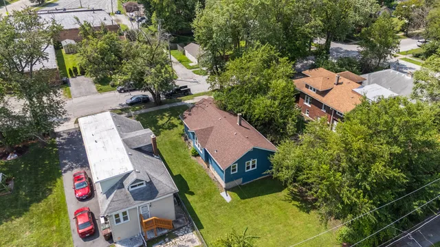 an aerial view of a house with a yard