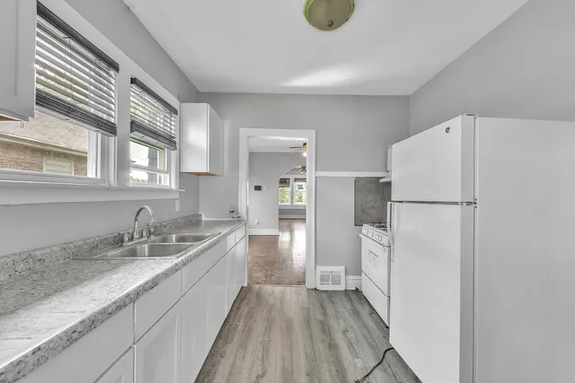 a kitchen with a refrigerator and a sink