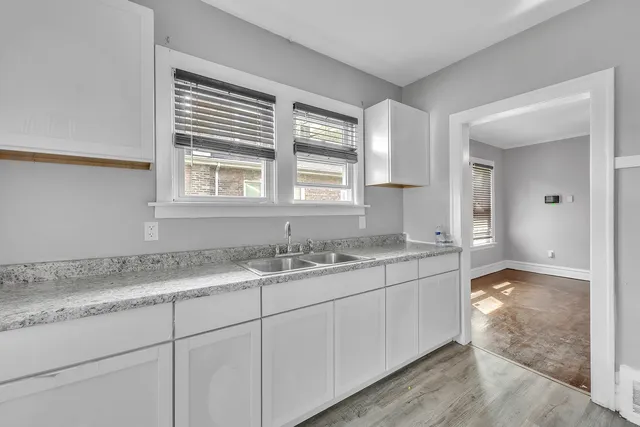 a bathroom with a granite countertop sink mirror and double