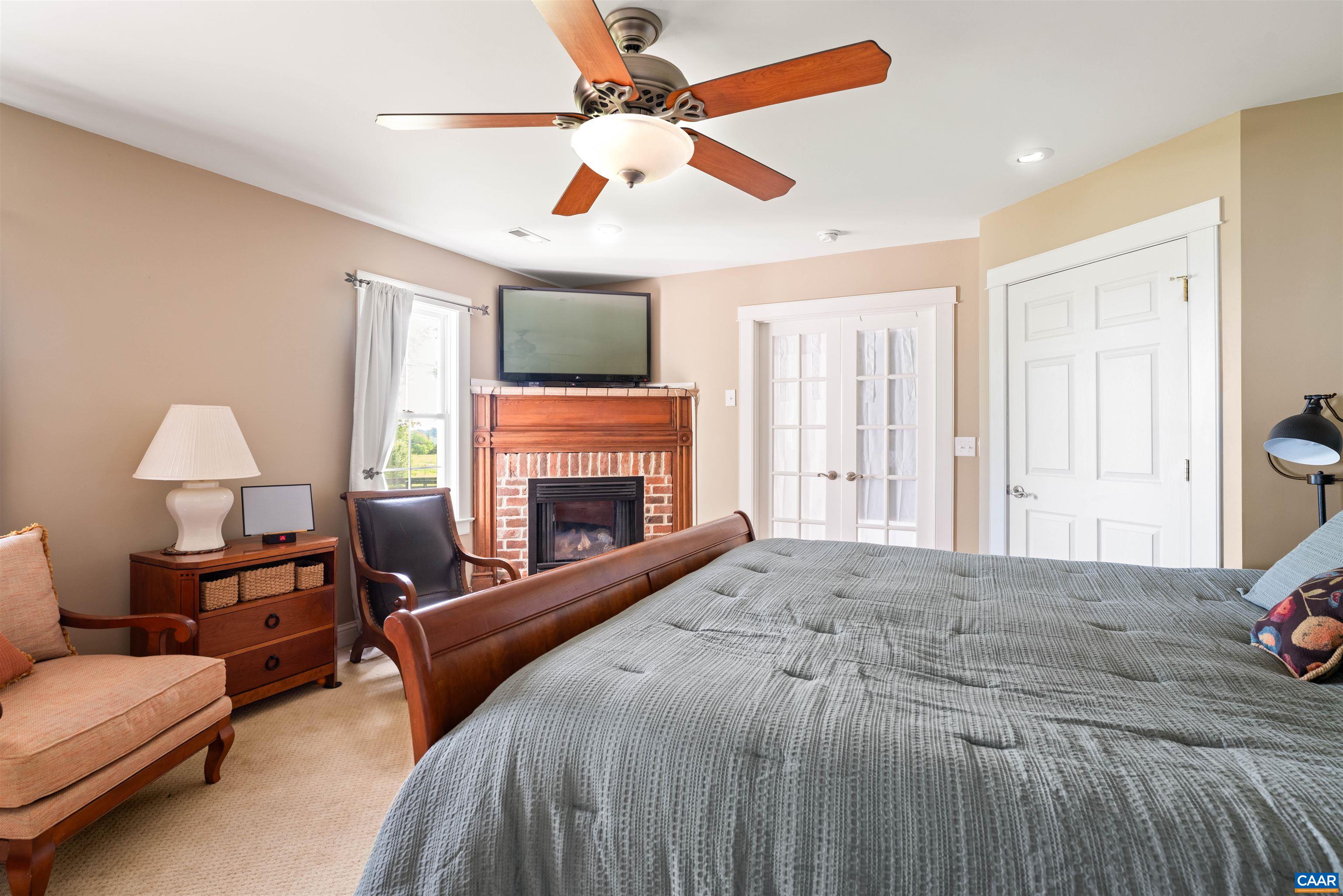 3486 Fredericksburg Road Ruckersville, VA 22968 - Photo 11 of 37 a spacious bedroom with a bed and a fireplace