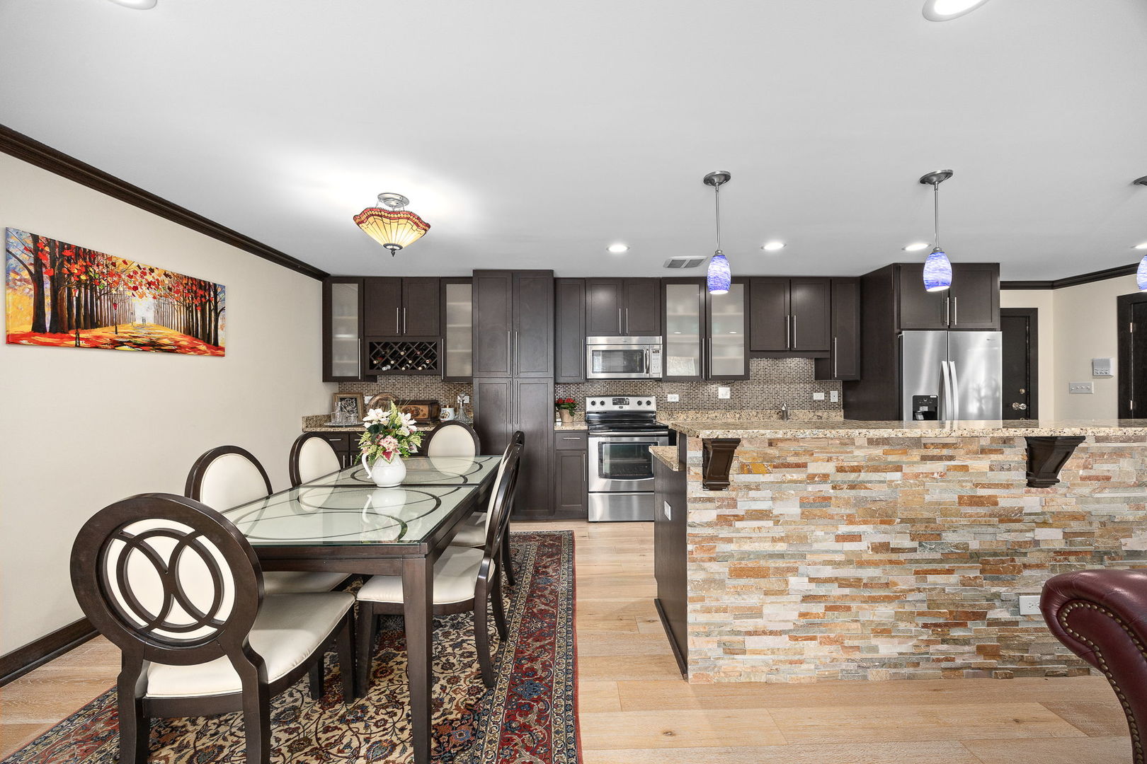 140 Carriage Way Drive, Unit C218 Burr Ridge, IL 60527 - Photo 15 of 33 a dining room with furniture and a kitchen view