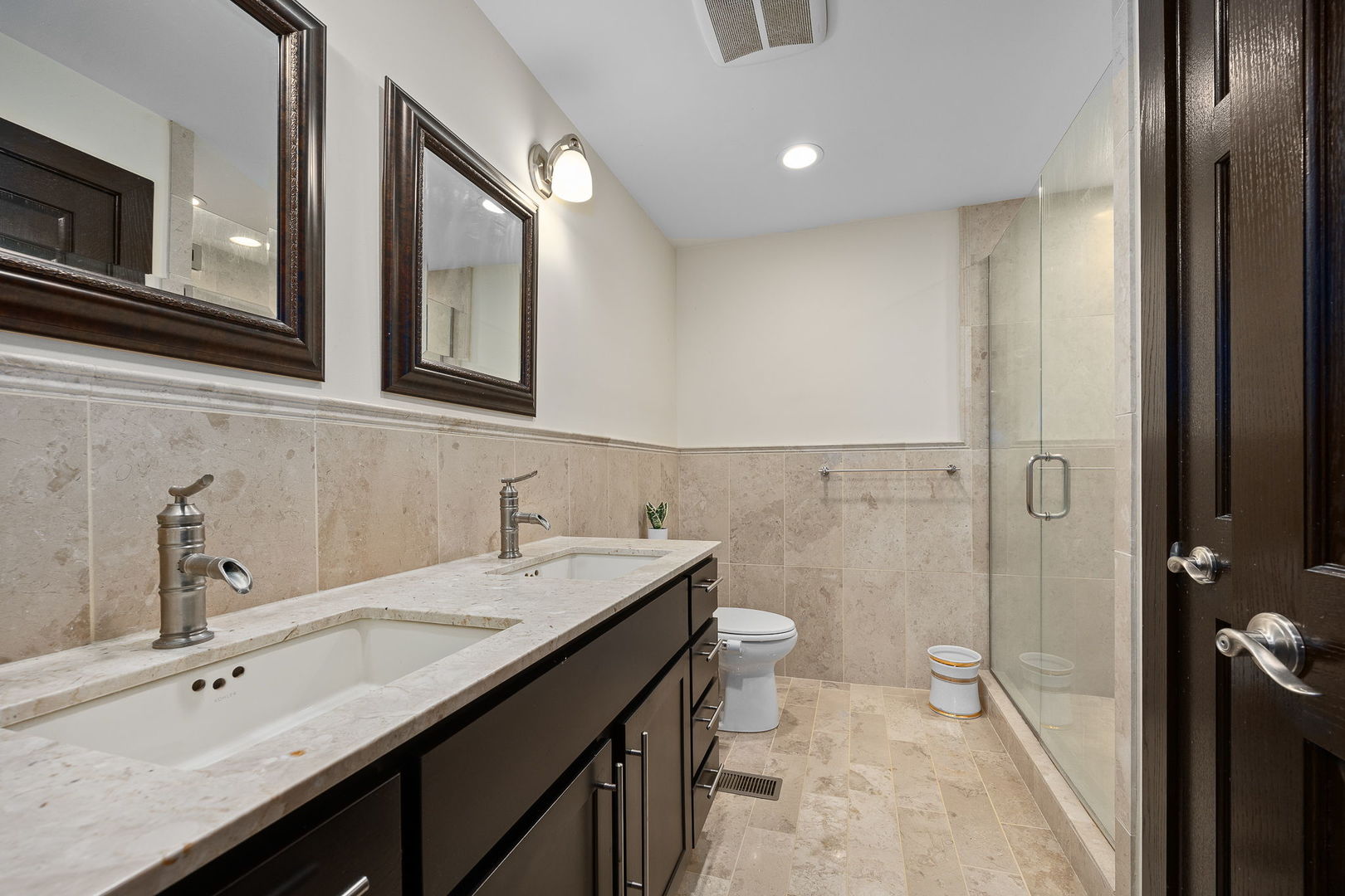 140 Carriage Way Drive, Unit C218 Burr Ridge, IL 60527 - Photo 19 of 33 a bathroom with a double vanity sink toilet and shower