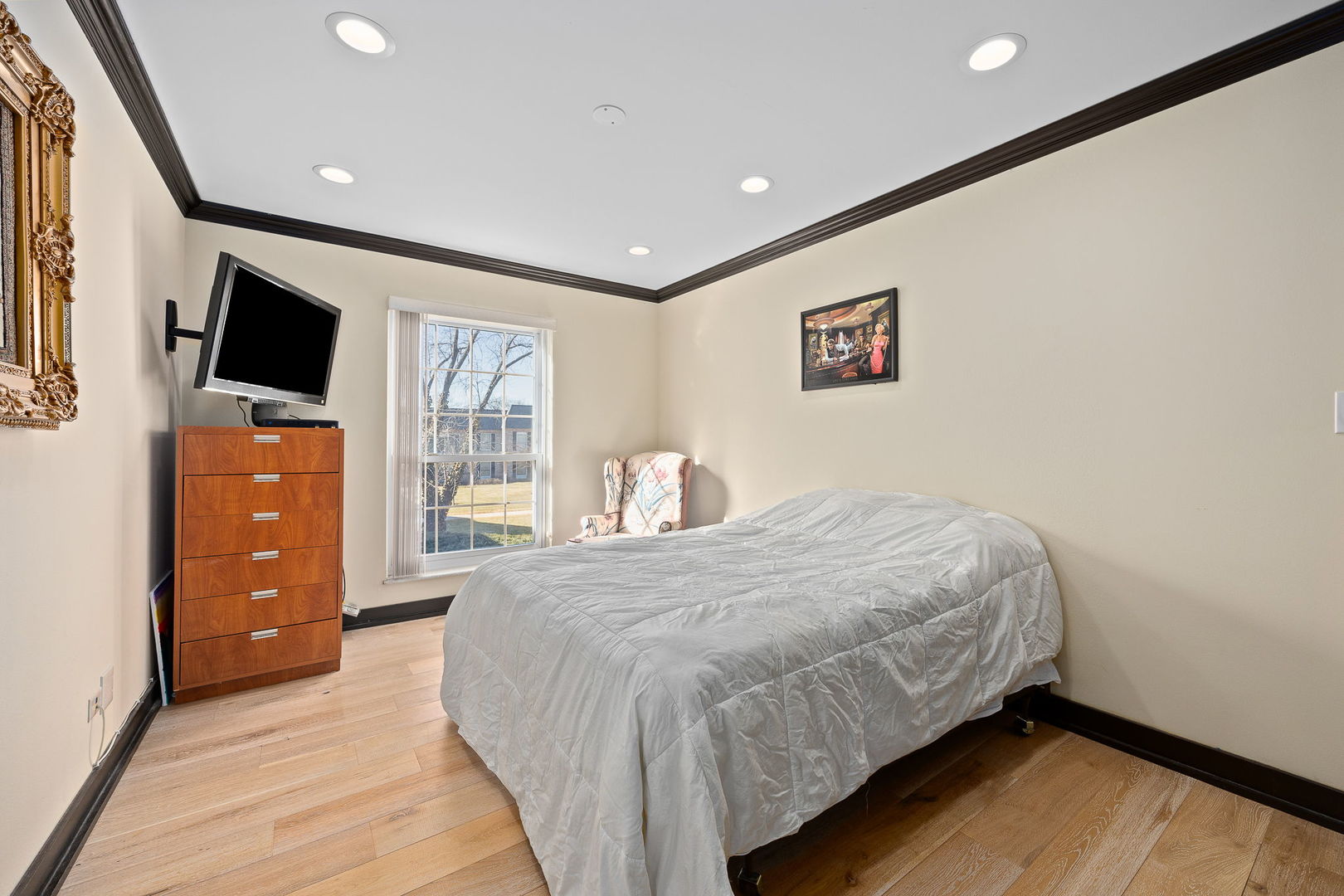 140 Carriage Way Drive, Unit C218 Burr Ridge, IL 60527 - Photo 20 of 33 a bedroom with a bed and a flat screen tv