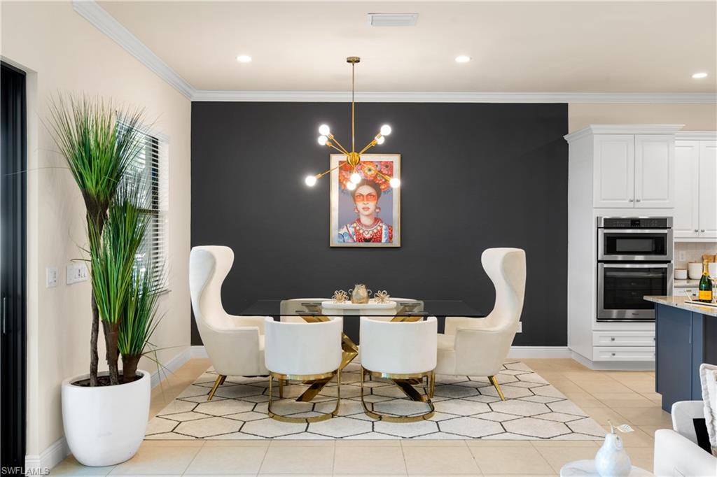 10137 Florence Circle Naples, FL 34119 - Photo 11 of 42 a dining room with furniture and window