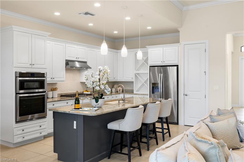 10137 Florence Circle Naples, FL 34119 - Photo 12 of 42 a kitchen with a sink stainless steel appliances and cabinets