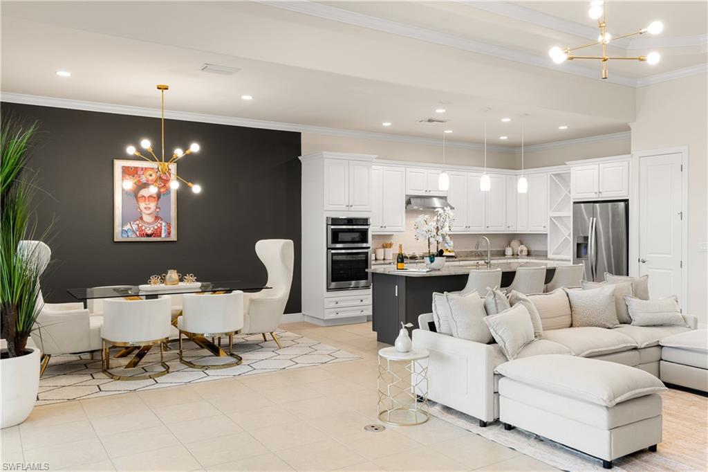 10137 Florence Circle Naples, FL 34119 - Photo 14 of 42 a living room with furniture and a dining table with kitchen view
