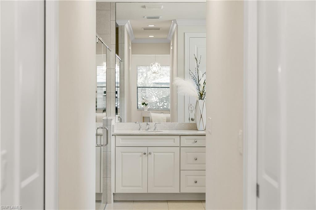 10137 Florence Circle Naples, FL 34119 - Photo 20 of 42 a bathroom with a granite countertop sink and a mirror