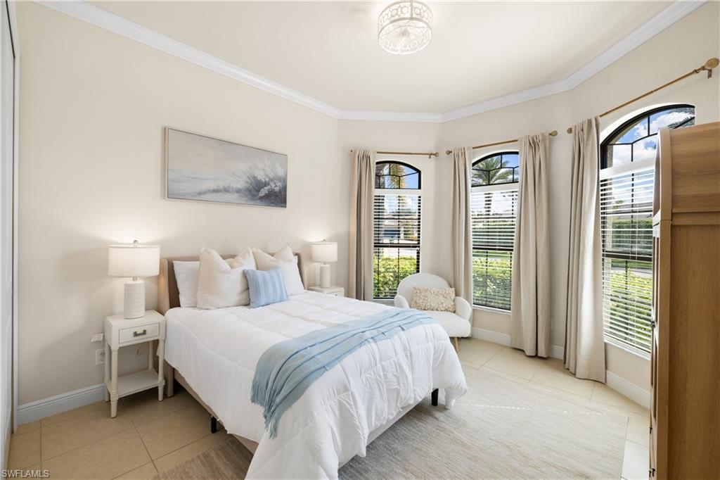 10137 Florence Circle Naples, FL 34119 - Photo 21 of 42 a bedroom with a bed and a large window
