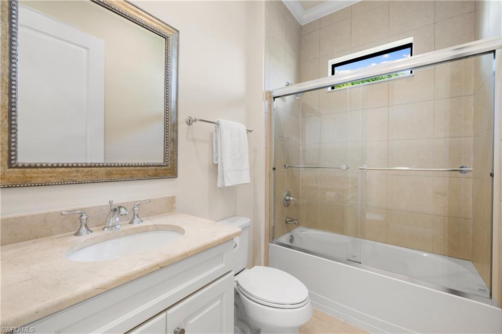 10137 Florence Circle Naples, FL 34119 - Photo 23 of 42 a bathroom with a granite countertop sink toilet and shower