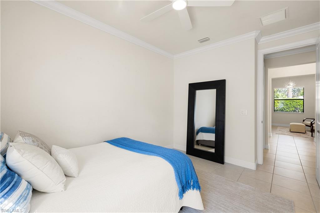 10137 Florence Circle Naples, FL 34119 - Photo 25 of 42 a bedroom with a bed and a couch