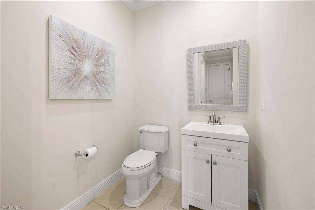 10137 Florence Circle Naples, FL 34119 - Photo 26 of 42 a bathroom with a toilet sink and mirror