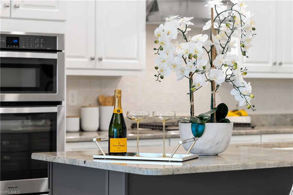10137 Florence Circle Naples, FL 34119 - Photo 33 of 42 a kitchen with a sink a microwave and cabinets