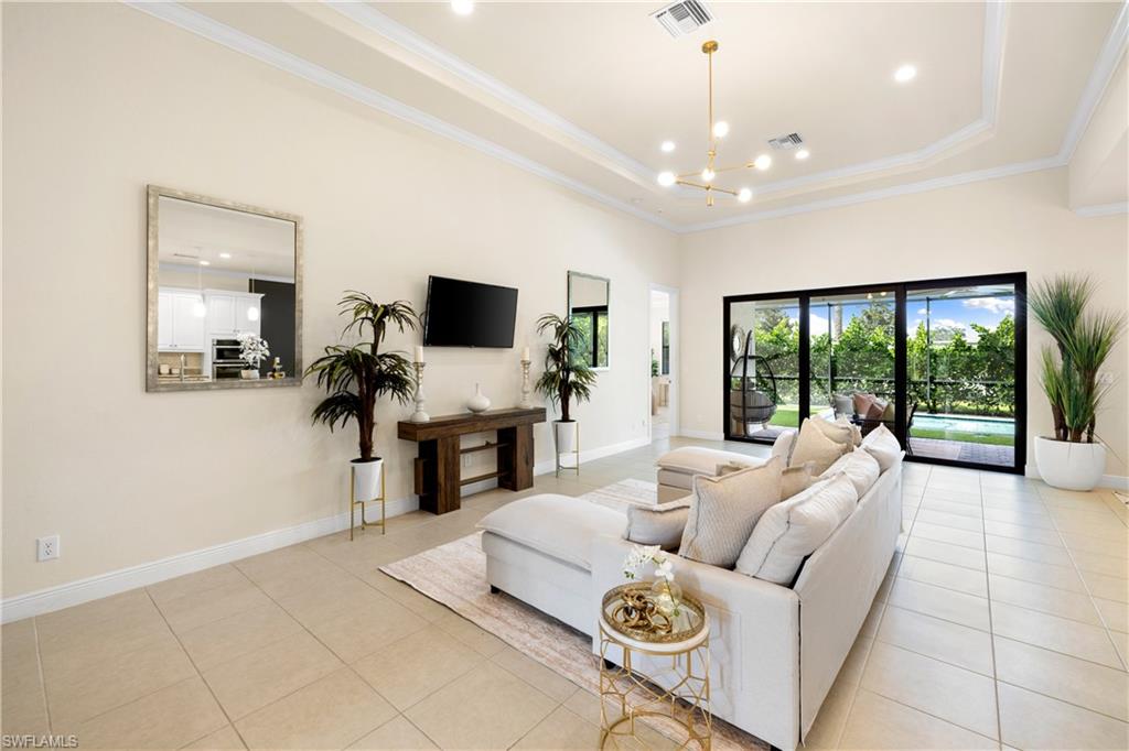 10137 Florence Circle Naples, FL 34119 - Photo 5 of 42 a living room with furniture and a flat screen tv