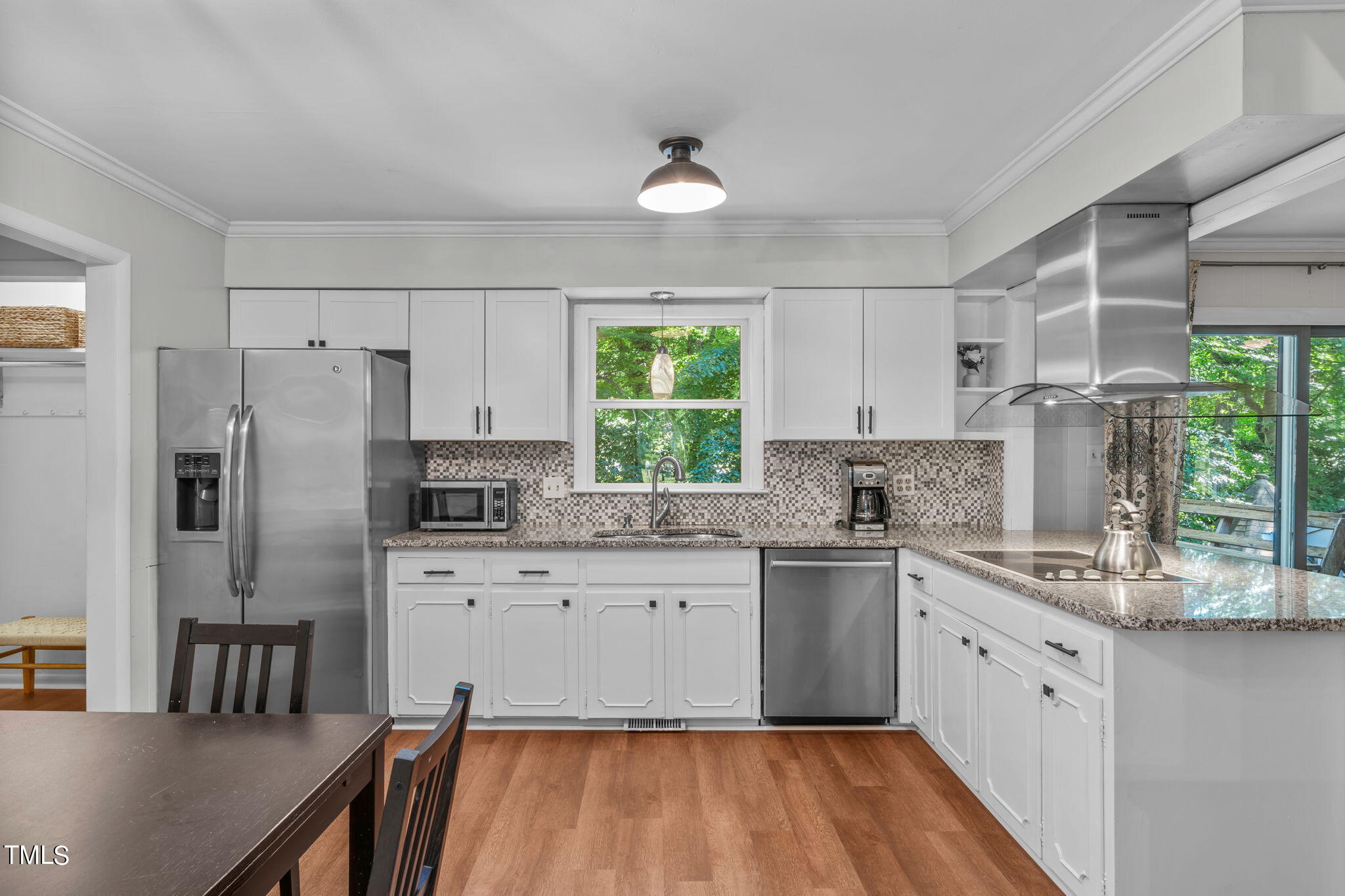 517 Compton Road Raleigh, NC 27609 - Photo 13 of 51 a kitchen with stainless steel appliances granite countertop a stove a sink dishwasher a refrigerator and white cabinets with wooden floor