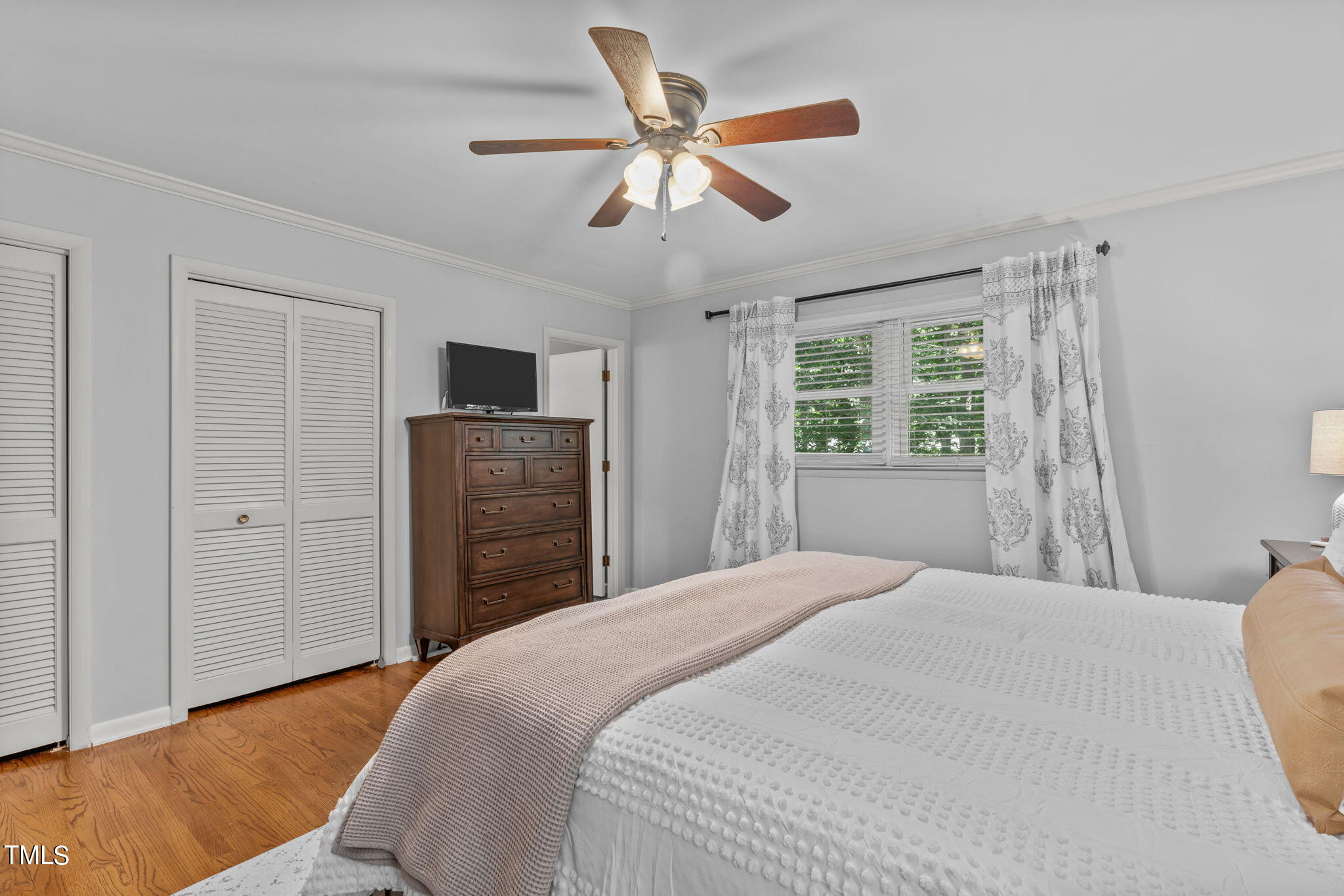517 Compton Road Raleigh, NC 27609 - Photo 23 of 51 a bedroom with a bed and a tv