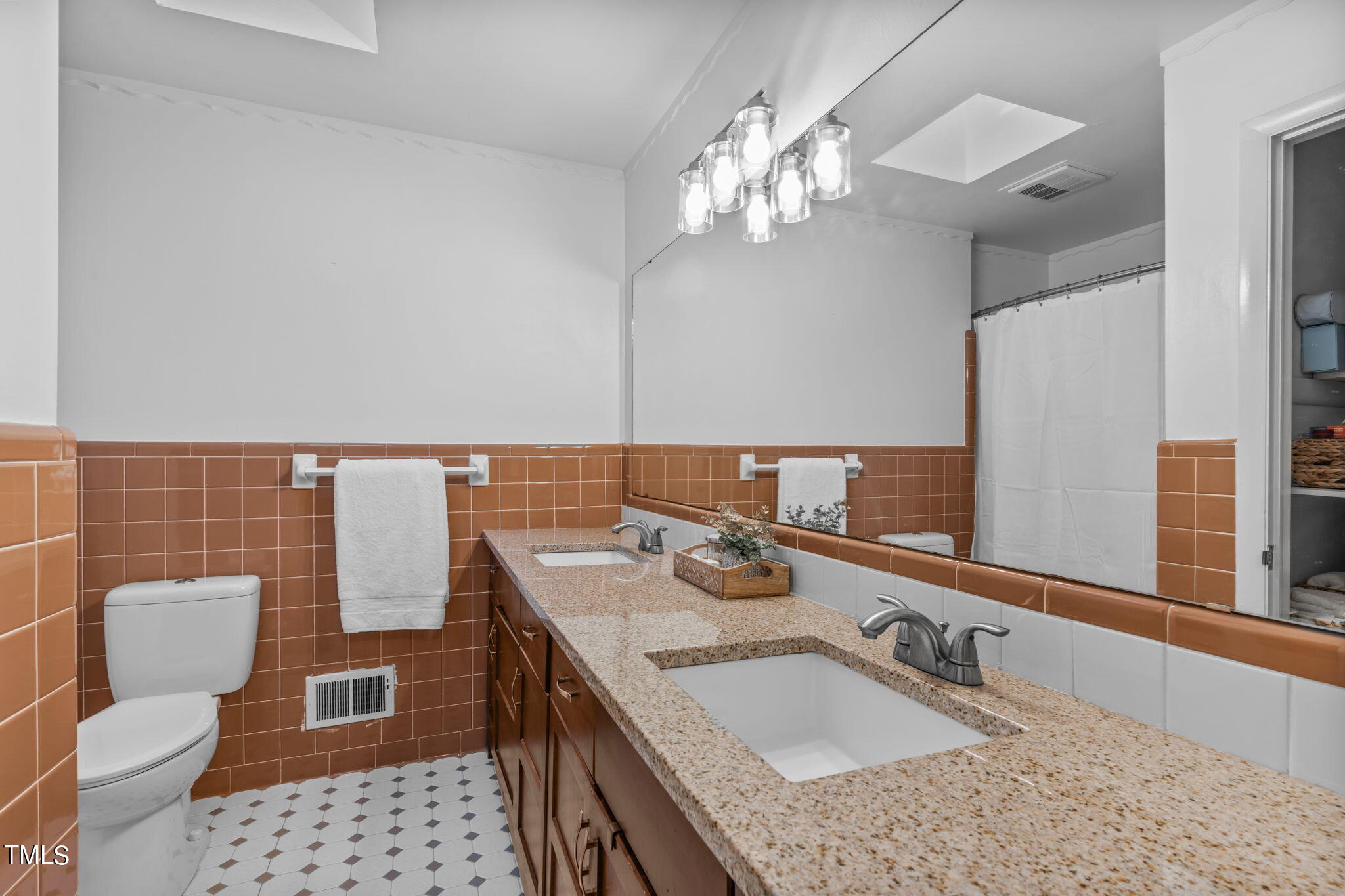 517 Compton Road Raleigh, NC 27609 - Photo 27 of 51 a bathroom with a sink a toilet and a mirror