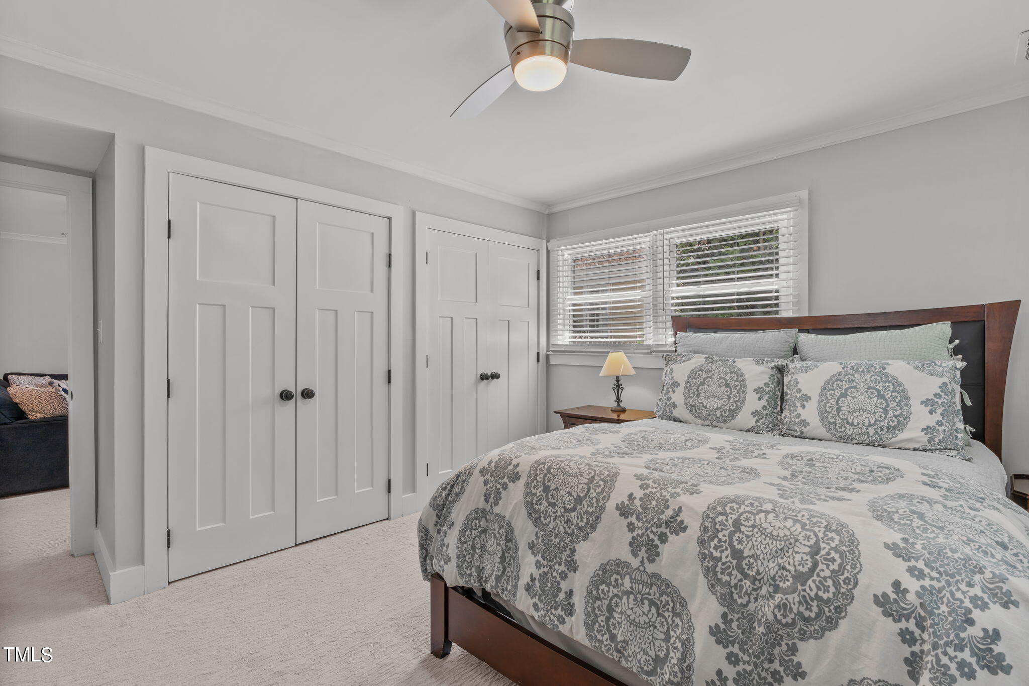 517 Compton Road Raleigh, NC 27609 - Photo 36 of 51 a bedroom with a large bed and a chandelier fan