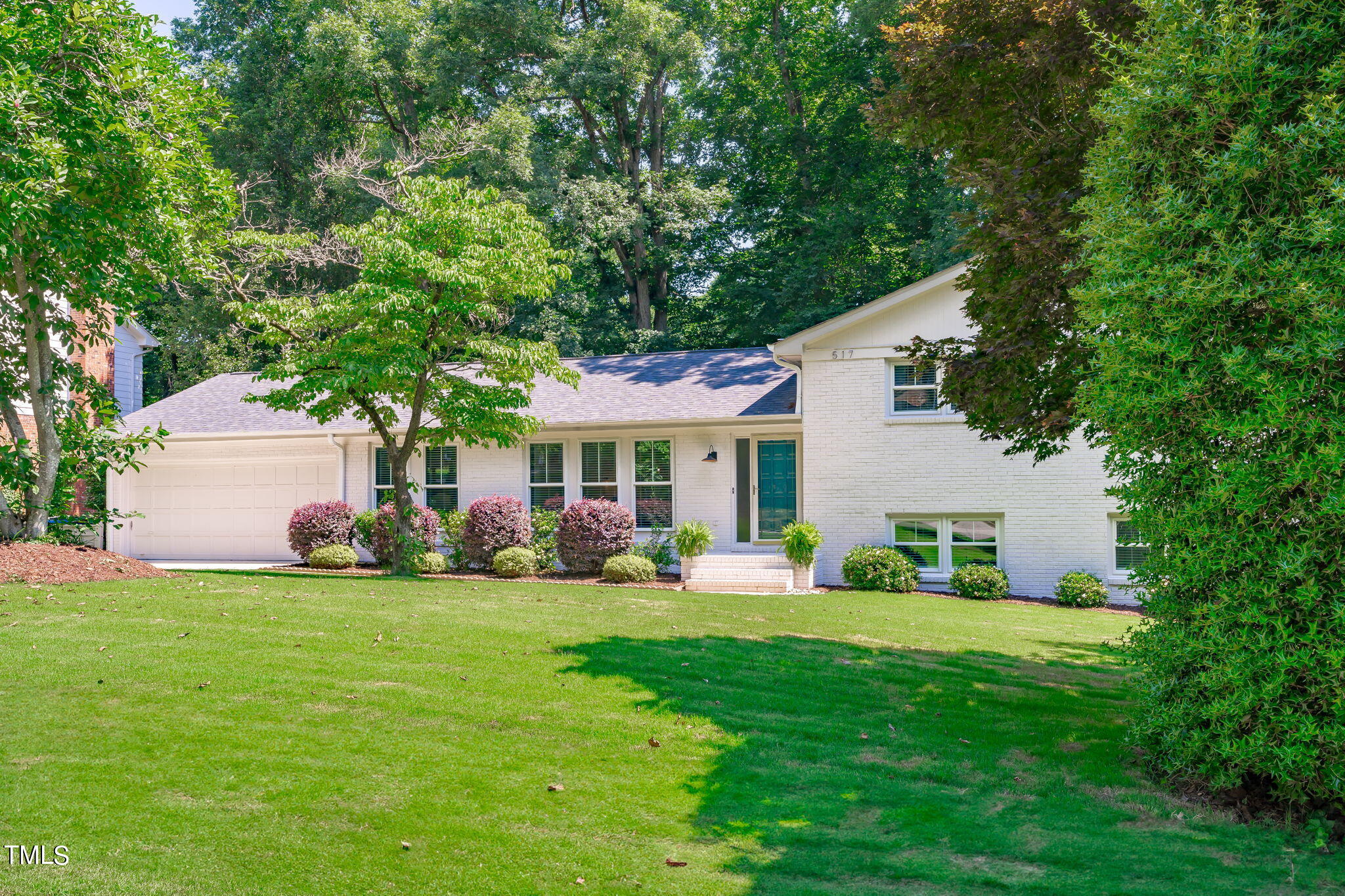 517 Compton Road Raleigh, NC 27609 - Photo 4 of 51 a front view of a house with a yard and trees