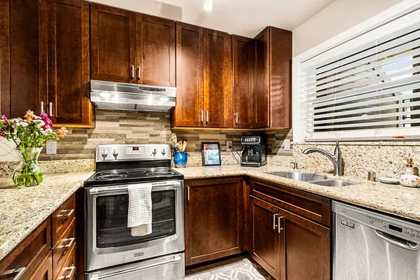 a kitchen with a sink stove and cabinets