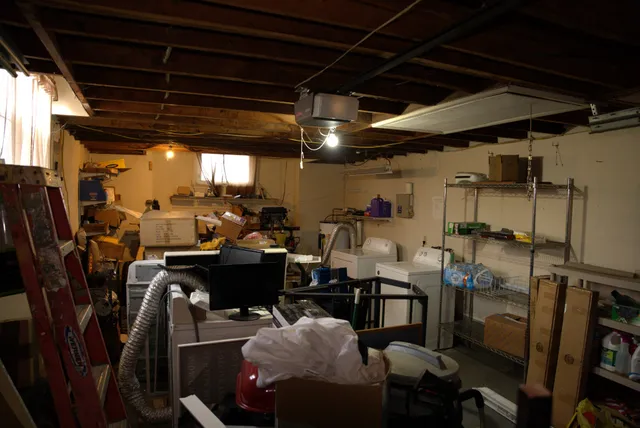 a kitchen with stainless steel appliances granite countertop a refrigerator a sink a stove a dining table and chairs