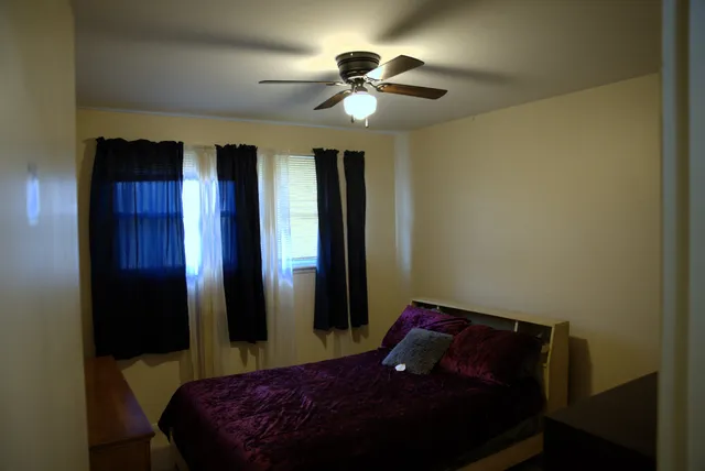a bedroom with a bed and a chandelier