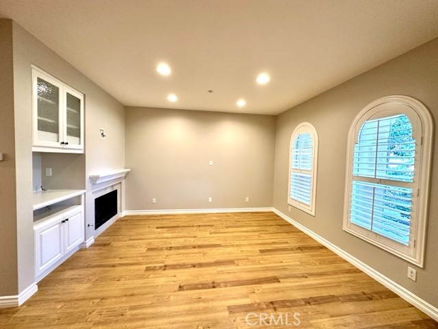 10 Paseo Rosa San Clemente, CA 92673 - Photo 11 of 46 a view of empty room with kitchen view and wooden floor