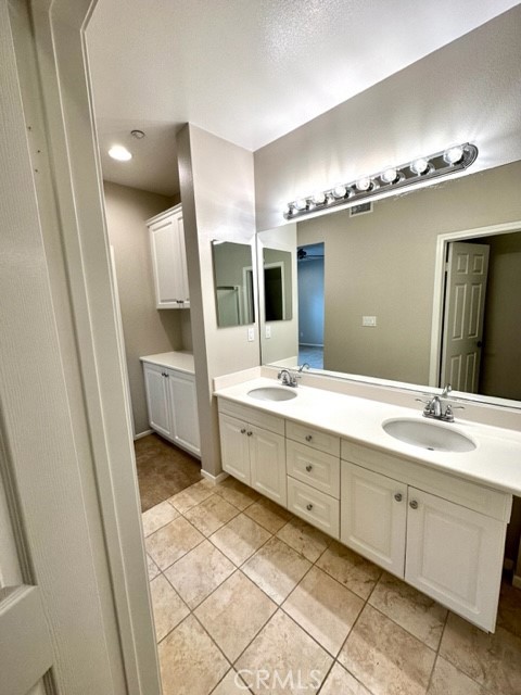 10 Paseo Rosa San Clemente, CA 92673 - Photo 16 of 46 a spacious bathroom with a double vanity sink and a mirror