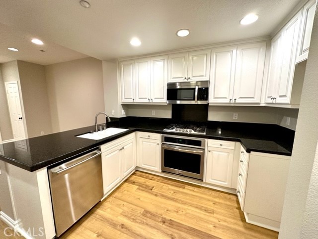 10 Paseo Rosa San Clemente, CA 92673 - Photo 4 of 46 a kitchen with a sink and a stove top oven