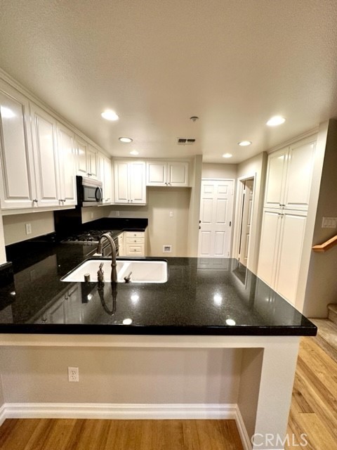 10 Paseo Rosa San Clemente, CA 92673 - Photo 6 of 46 a kitchen with a table chairs sink and cabinets