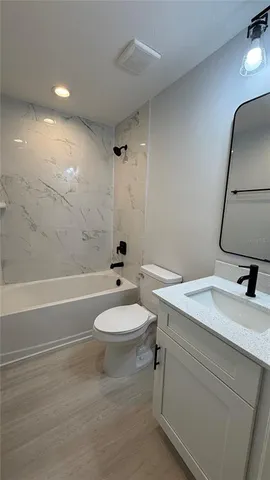 a bathroom with a sink a toilet and a bathtub