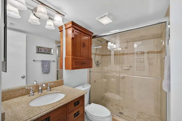 a kitchen with stainless steel appliances granite countertop a refrigerator a stove and a refrigerator