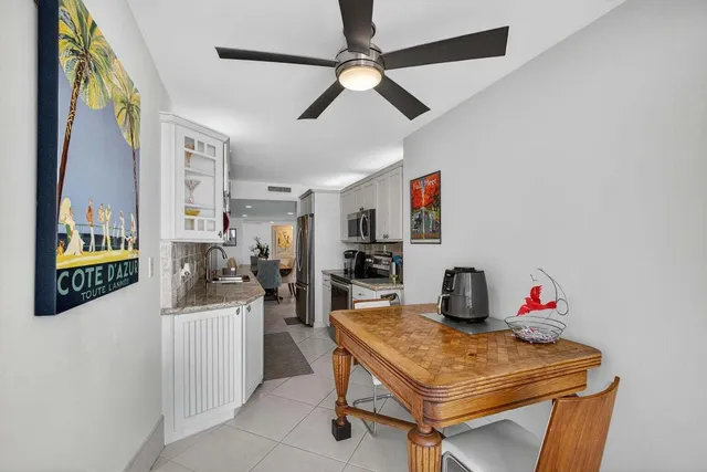 a bedroom with a bed and a large window with view of swimming pool