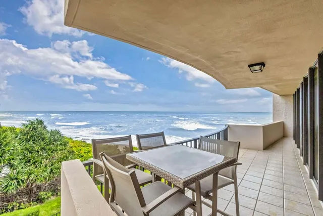 a swimming pool with outdoor seating and garden