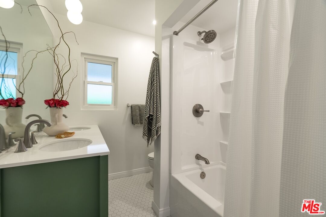 4367 Globe Avenue Culver City, CA 90230 - Photo 13 of 34 a bathroom with a sink a mirror and a shower