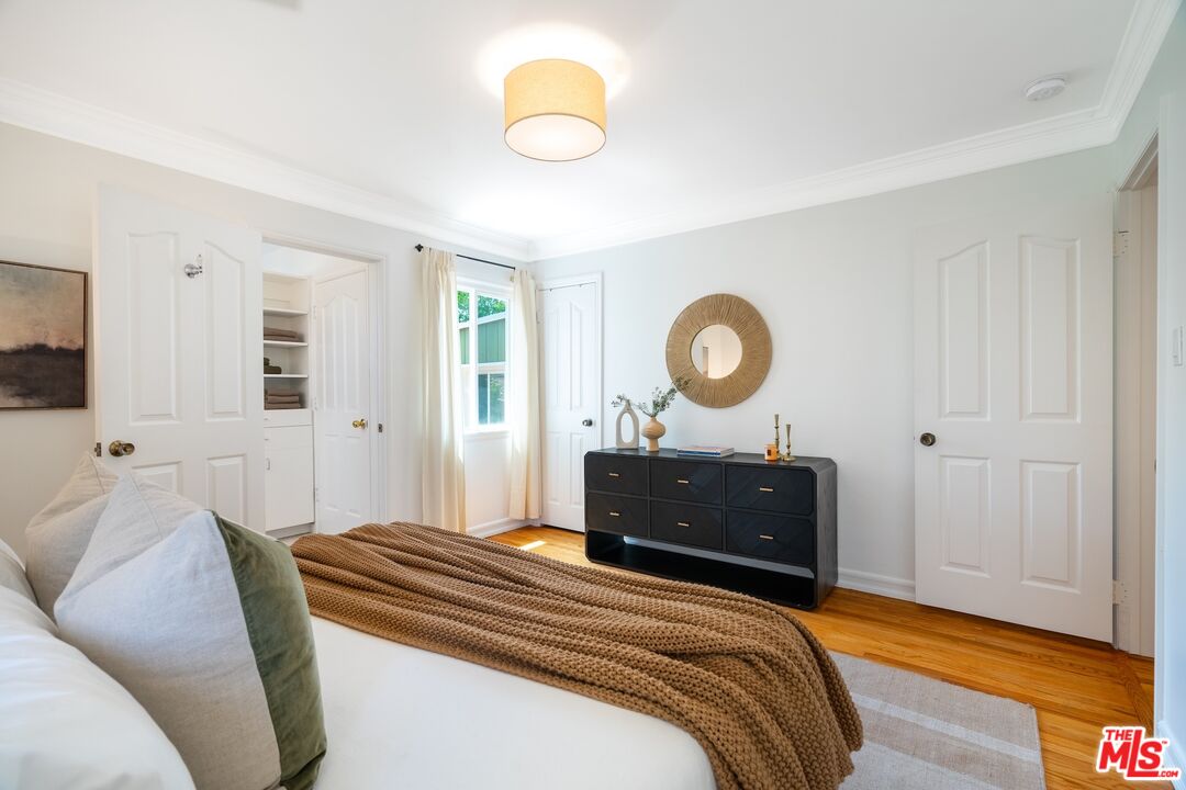 4367 Globe Avenue Culver City, CA 90230 - Photo 15 of 34 a bedroom with a bed and a chandelier