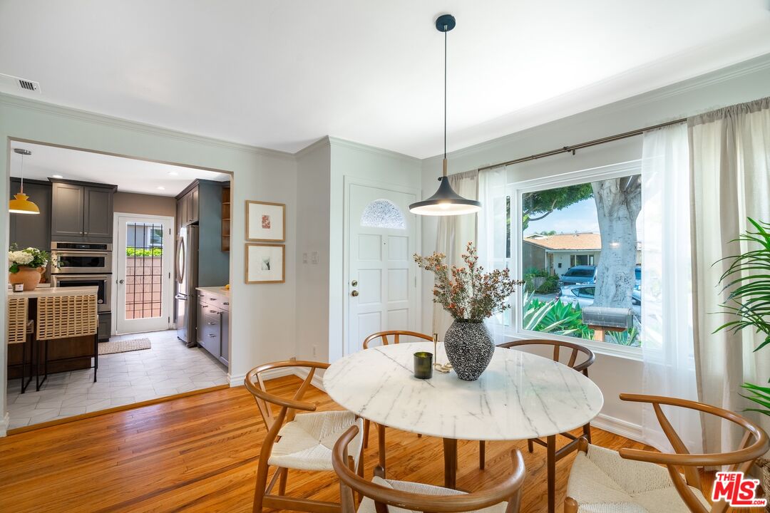 4367 Globe Avenue Culver City, CA 90230 - Photo 5 of 34 a dining room with furniture a chandelier and wooden floor