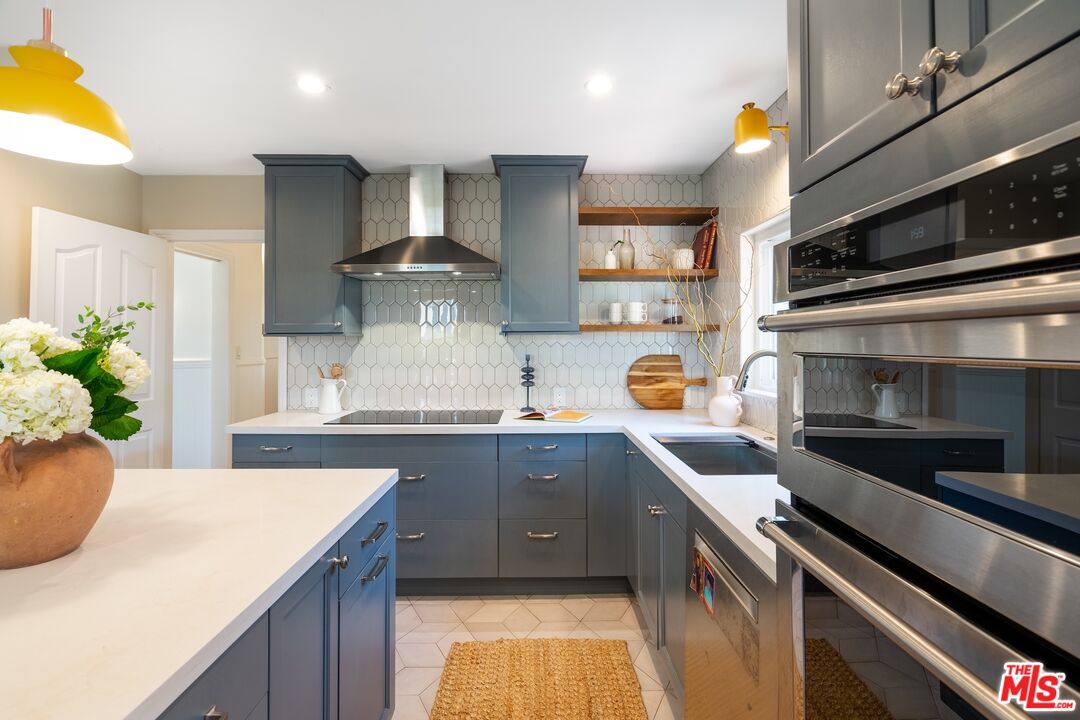 4367 Globe Avenue Culver City, CA 90230 - Photo 7 of 34 a kitchen with granite countertop a sink stainless steel appliances and cabinets