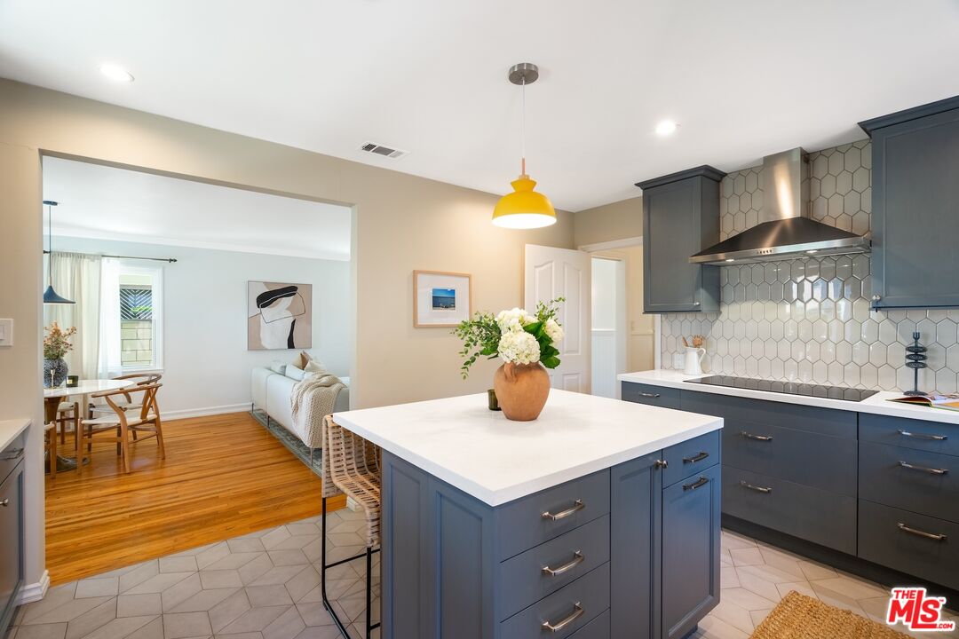 4367 Globe Avenue Culver City, CA 90230 - Photo 8 of 34 a kitchen with a dining table cabinets and wooden floor
