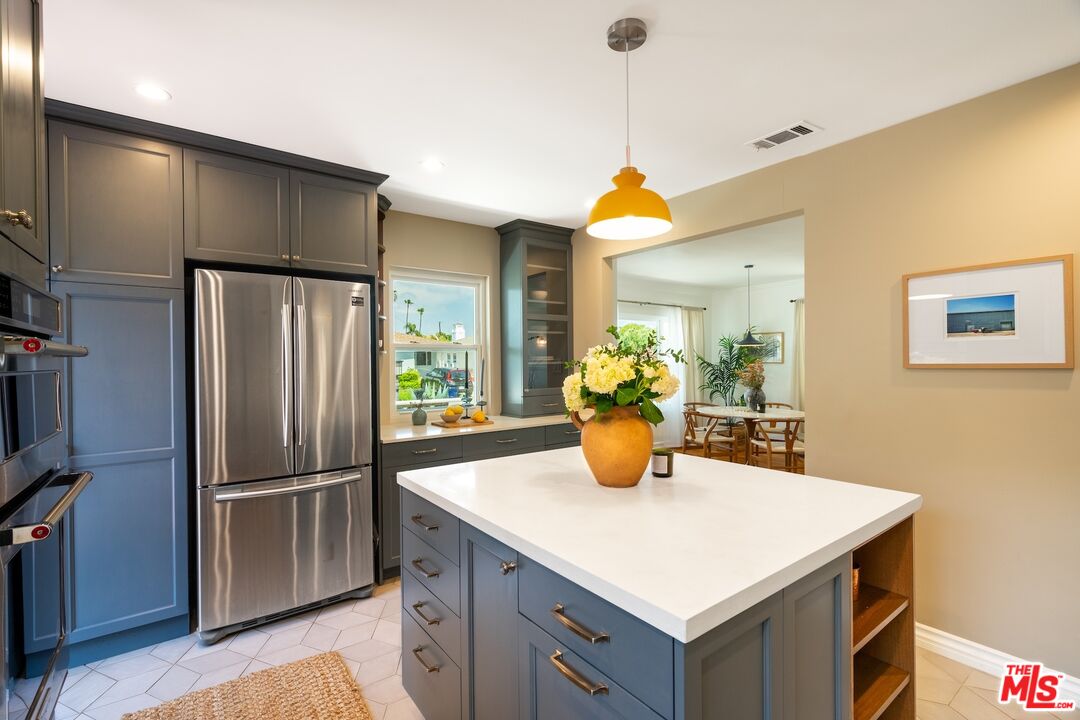 4367 Globe Avenue Culver City, CA 90230 - Photo 10 of 34 a kitchen with a refrigerator a sink and cabinets