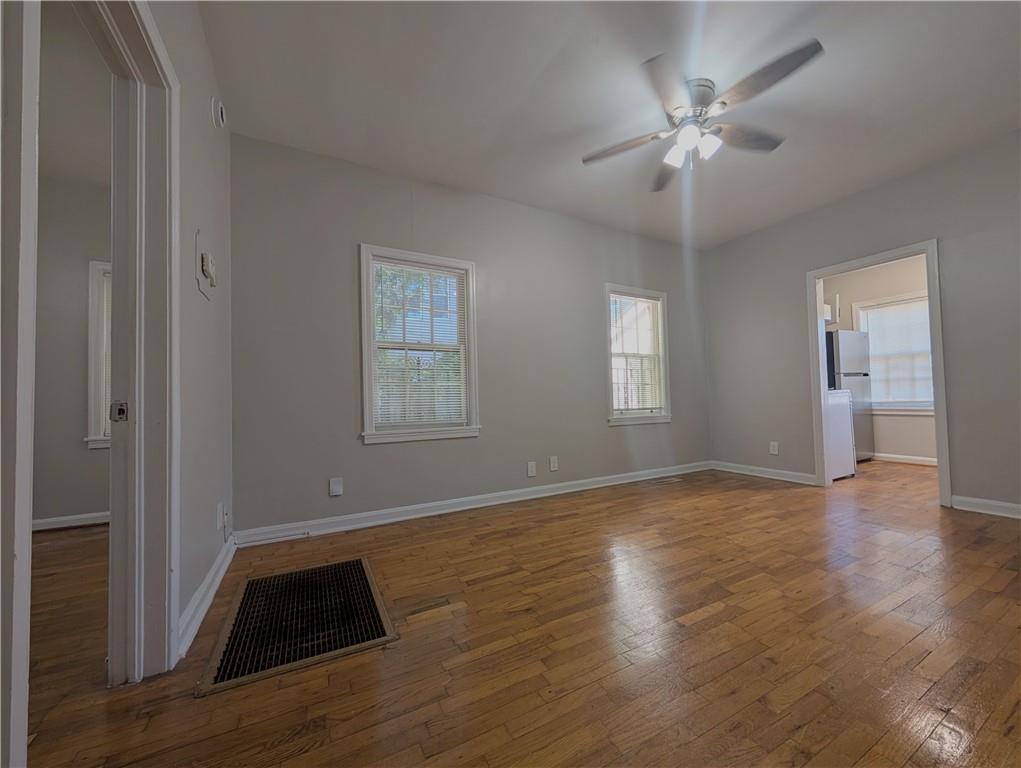 3548 East Main Street, Unit 2 Atlanta, GA 30337 - Photo 4 of 13 a view of an empty room with a window and wooden floor