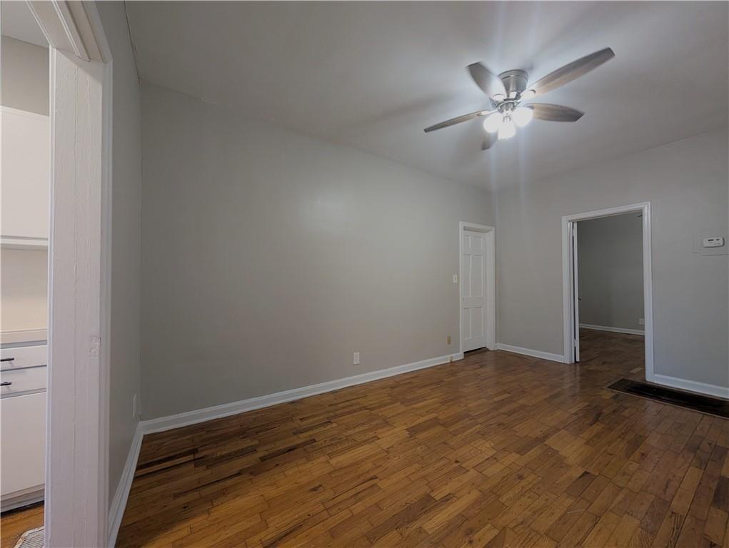 3548 East Main Street, Unit 2 Atlanta, GA 30337 - Photo 5 of 13 a view of an empty room with wooden floor and a chandelier fan