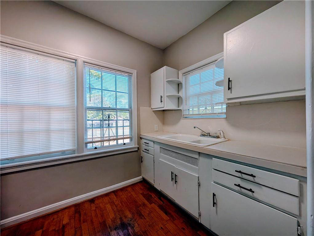 3548 East Main Street, Unit 2 Atlanta, GA 30337 - Photo 6 of 13 a kitchen with granite countertop white cabinets and white appliances