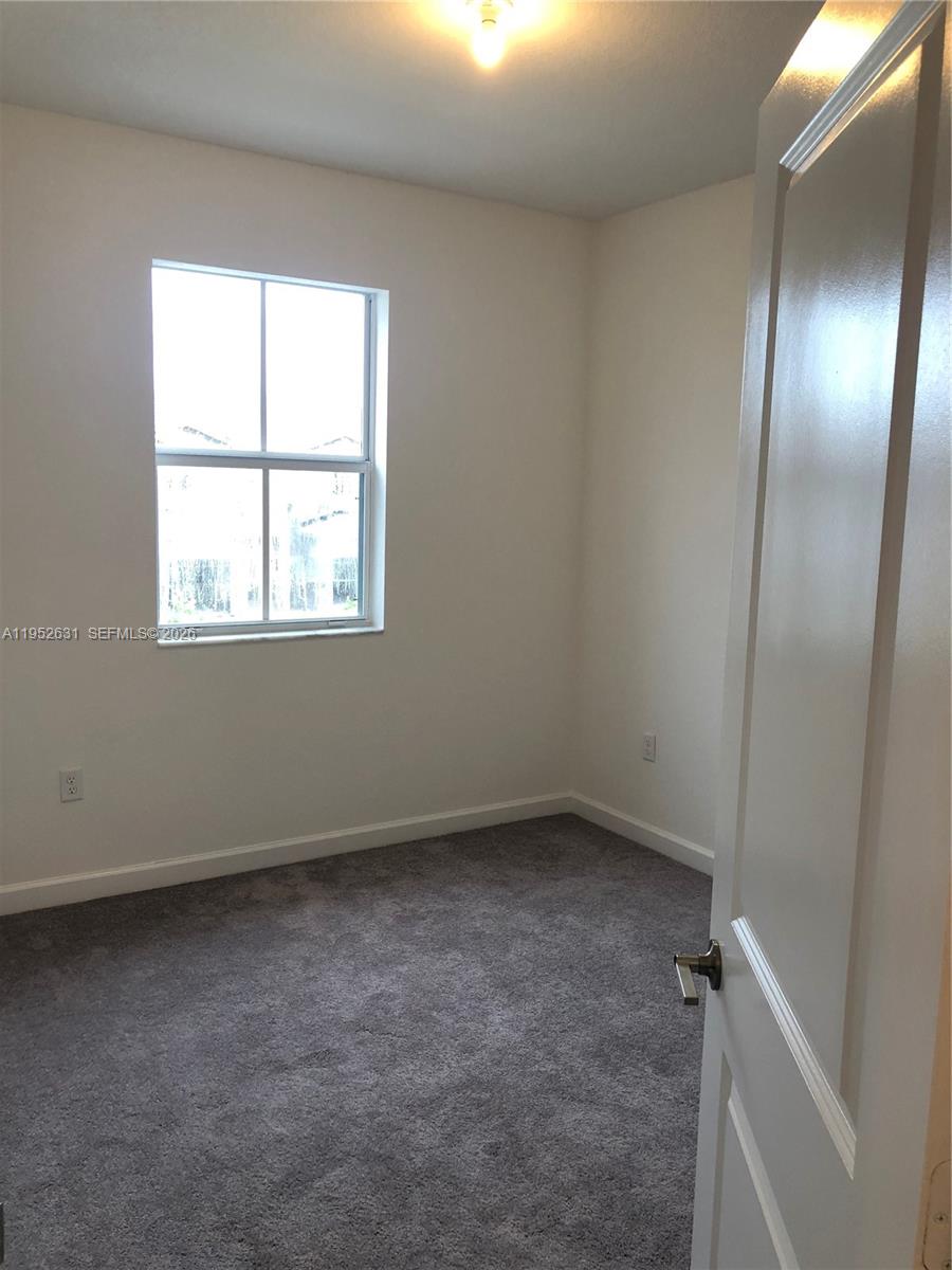 2610 Southeast 13th Street Homestead, FL 33035 - Photo 12 of 24 an empty room with a window