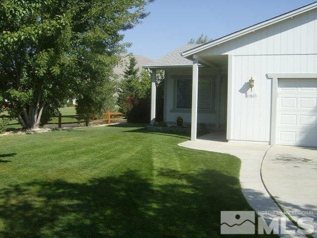 a backyard of a house with table and chairs