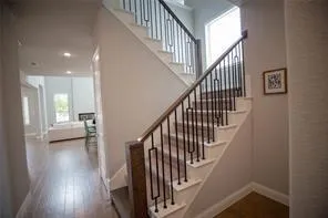 a view of entryway and hall with wooden floor