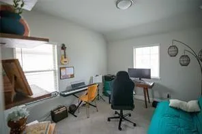 a view of a workspace with furniture and a window