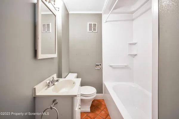 a bathroom with a sink a mirror and a bathtub