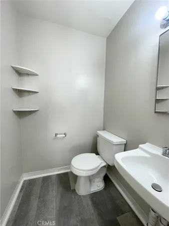 a white toilet sitting next to a bathroom sink