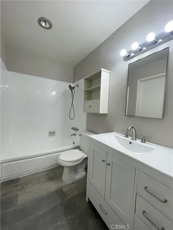 a bathroom with a double vanity sink mirror and toilet