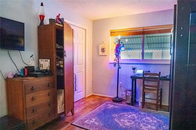 a bed room with a bed and a television